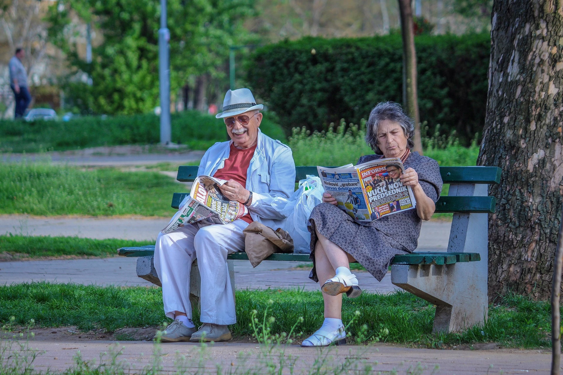 grandparents on a bench reading