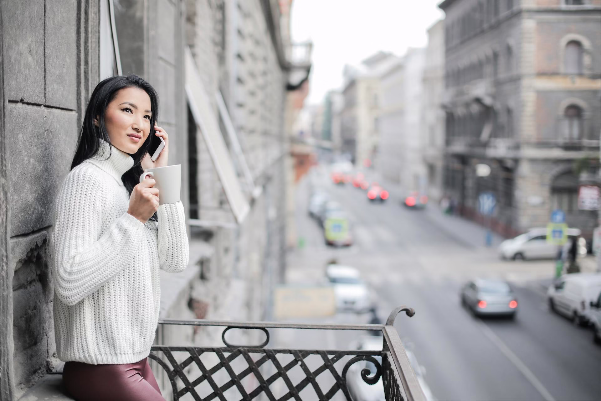 woman with phone in hand talking